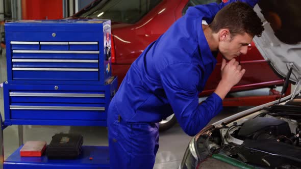 Mechanic servicing a car engine