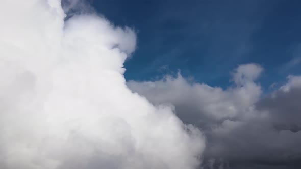 Aerial View From Airplane Window at High Altitude of Earth Covered with Puffy Cumulus Clouds Forming