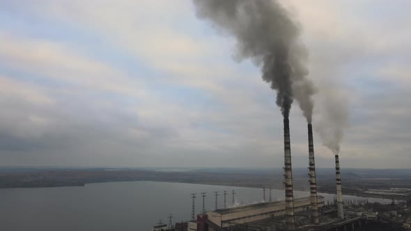 Aerial View of Coal Power Plant High Pipes with Black Smoke Moving Up Polluting Atmosphere