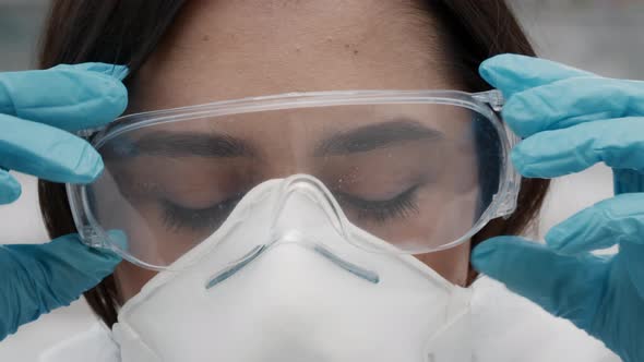 Medical Worker Taking Off Hazmat Suit And FFP Mask Outdoor