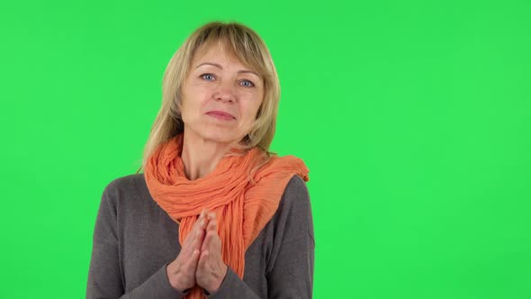 Portrait of Middle Aged Blonde Woman Is Waiting in Anticipation with Pleasure. Green Screen