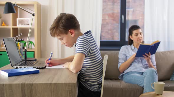 Student Boy with Laptop Learning Online at Home