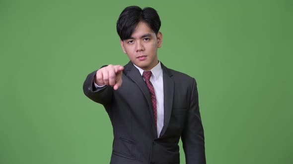 Young Handsome Asian Businessman Pointing To Camera