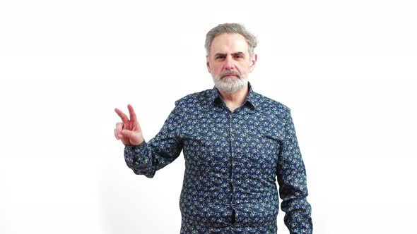 Mature Serious Man Shows Peace Sign on White Background Copy Pace Medium Shot