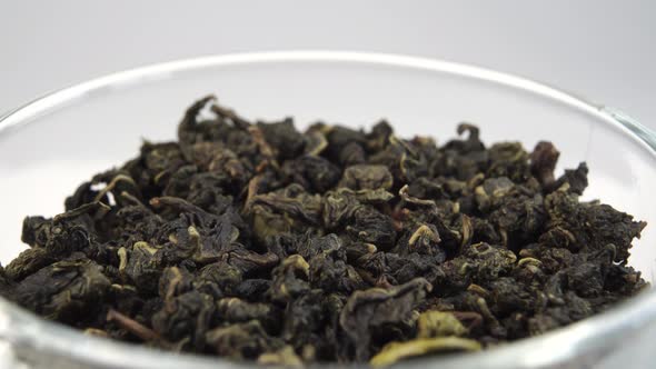 Dried Chinese green tea leaves. Rolled up pressed tea leaf
