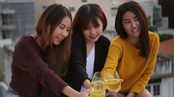 Young asian girl friends hanging out with drinks. Holiday celebration festive party.