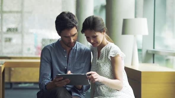 Couple using digital tablet together