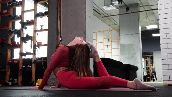 Young Woman Doing Pilates  Exercising Her Back