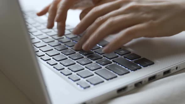 Woman Typing on Laptop Keyboard in the Office