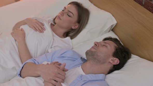 Beautiful Young Couple Having Nap in Bed