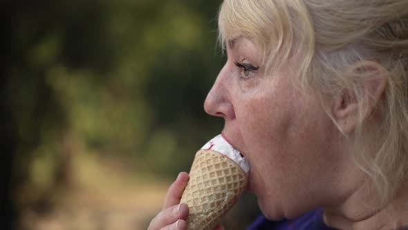 Woman Eating Icecream at the Street