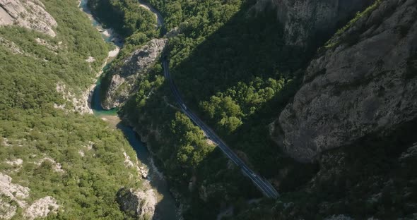 a car and a truck on the road in canyon