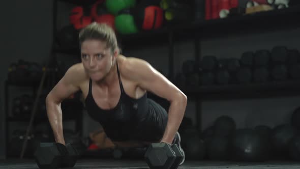 Athletic Beautiful Girl Athlete Doing Push Ups in the Gym