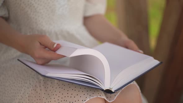 Girl Flipping Through a Book