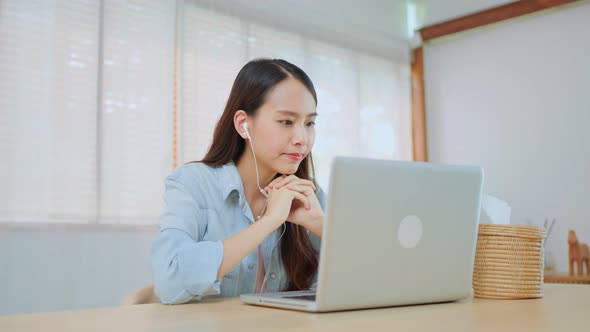 Asian young beautiful girl student stay at home, use laptop and spending leisure free time in house.