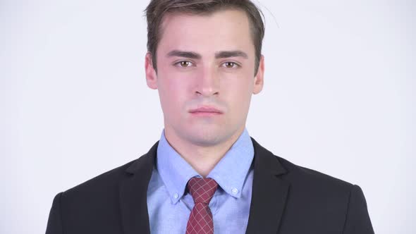 Head Shot of Young Handsome Businessman Wearing Suit