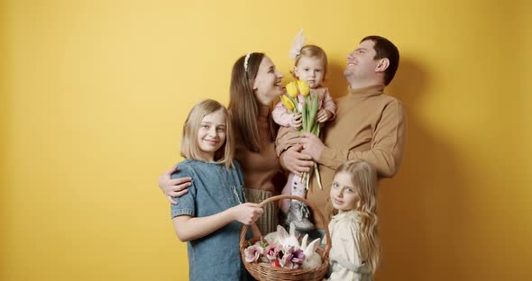 Happy Family Having Fun Time and Posing with Flowers and Rabbit Easter Day