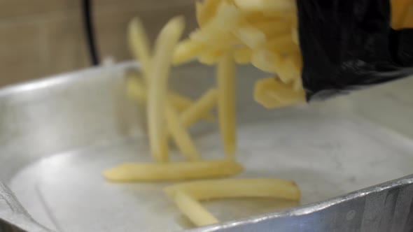 Frozen French Fries Are Put in a Metal Container for Weighing and Checking
