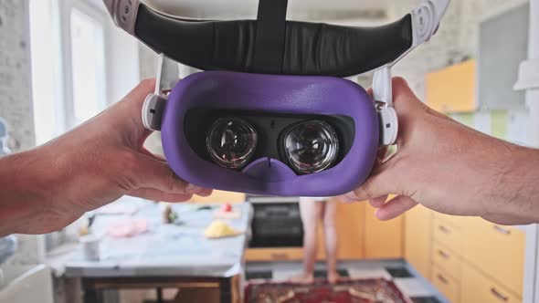 Man Taking On VR Helmet at Home Kitchen Point of View