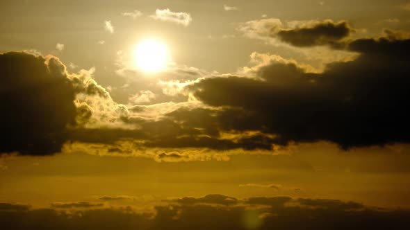 Dramatic Sunset with Sun Rays in Sky Through Orange Layered Clouds Timelapse