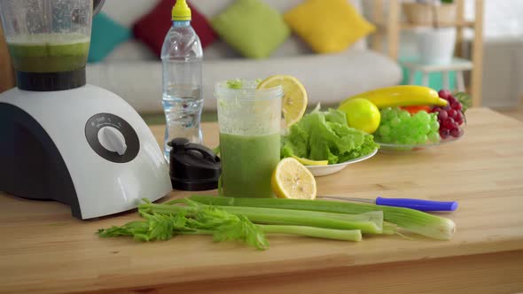 Concept Idea of Proper Nutrition, on the Table Celery Smoothies, Lemons, Salad,fruit and Water