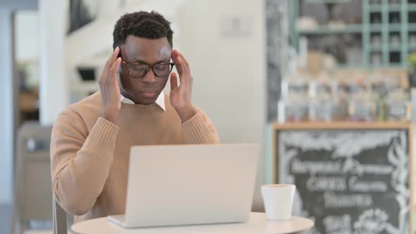 Creative African Man with Headache Working on Laptop