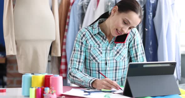 Seamstress Woman Talking on Mobile Phone and Writing Down Order Near Digital Tablet  Movie