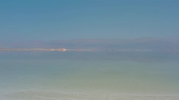 Woman Freelancer Works at a Laptop on the Shores of the Dead Sea 