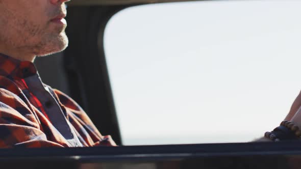 Caucasian man wearing sunglasses sitting in car driving on sunny day