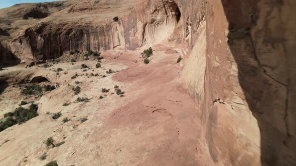 Aerial drone views as the camera flies through Corona Arch, west of Moab, Utah.