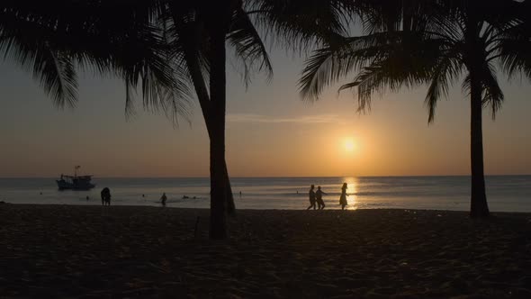 Picturesque Seascape with People Having Rest at Evening Beach