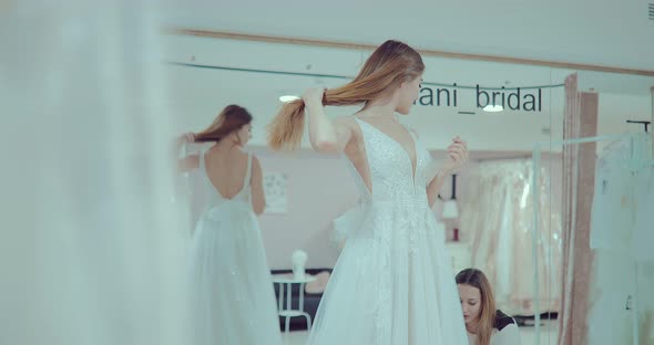 Happy and Beautiful Girl Trying on a Luxurious Wedding Dress