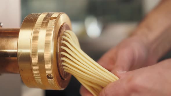 Man Making Fresh Pasta on Traditional Italian Kitchen Machine for Spaghetti Chef Preparing Fresca