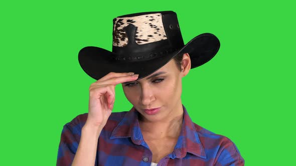 Confident Woman in Cowgirl Hat Looking To Camera on a Green Screen, Chroma Key.