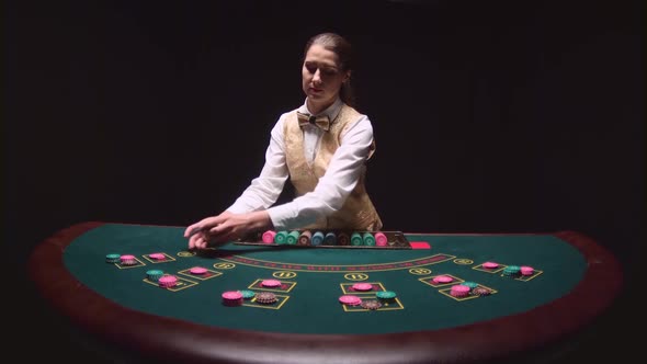 Casino Professional Dealer Shuffles the Poker Cards and Performing Trick with Cards. Black