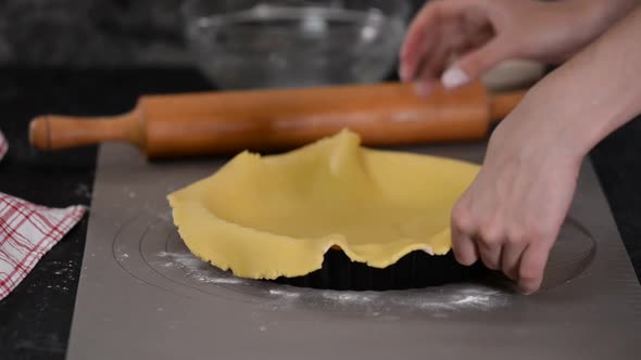 Woman Making French Tart at the Kitchen. The Chef Puts the Finished Dough Into a Mold