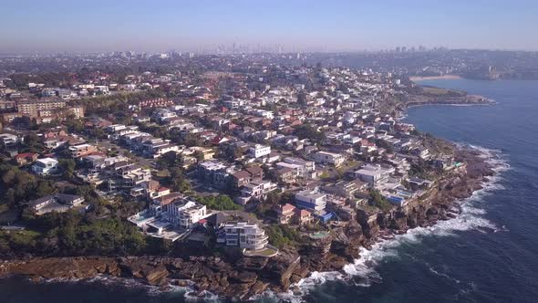 Birdeye view of Sydney eastern suburb coastal houses with city skyline, Australia.