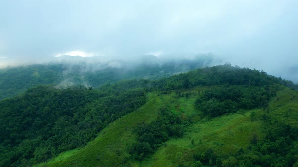 4K Aerial Drone shot flying over beautiful mountain ridge in rural jungle bush forest.