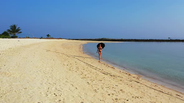 Modern beauty models on vacation enjoying life on beach on sunny blue and white sand background 4K