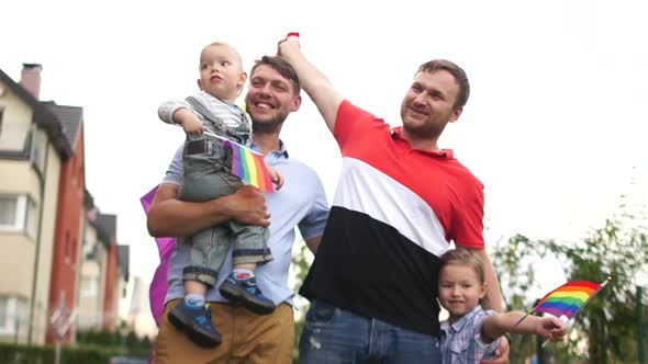 Gay Couple. Happy Same-sex Family Near Their House with Flags and Two Children, a Boy and a Girl