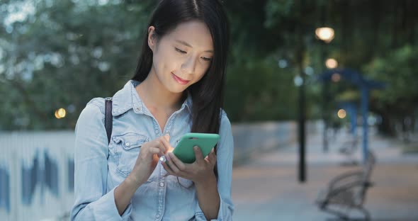 Woman use of cellphone at outdoor 