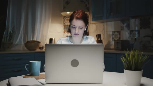 Woman In The Kitchen With Laptop.