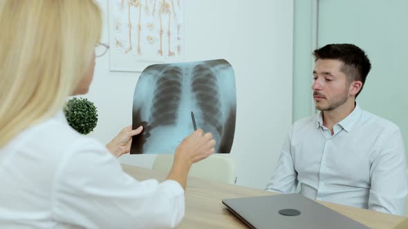 Friendly Doctor Woman Giving Good News Pulmonary XRay Man Patient in Hospital Indoor