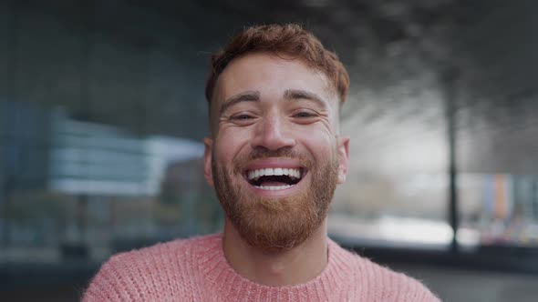 Happy young man smiling in camera