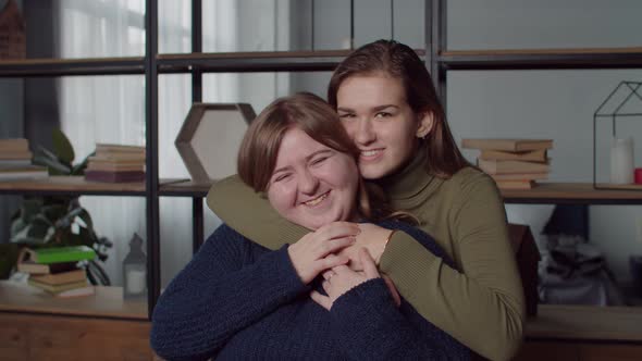 Portrait of Smiling Deaf Women Embracing at Home