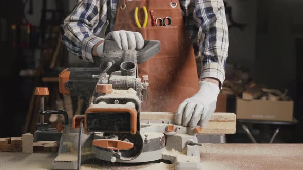 Carpenter Using an Electric Circular Saw Cutting Piece of Wood