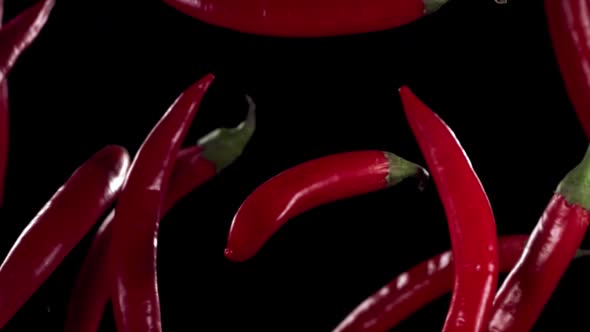 Super Slow Motion Shot of Flying Red Chilli Peppers in the Air