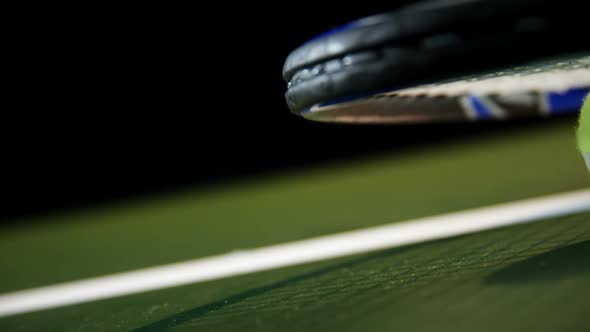 Racket and tennis ball in court