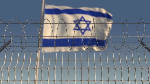 Defocused Flag of Israel Behind Barbed Wire Fence