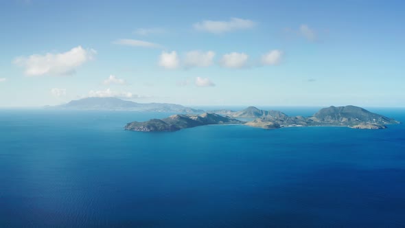 Aerial drone shoots view of mountainous islands in the blue sea in Saint Kitts and Nevis